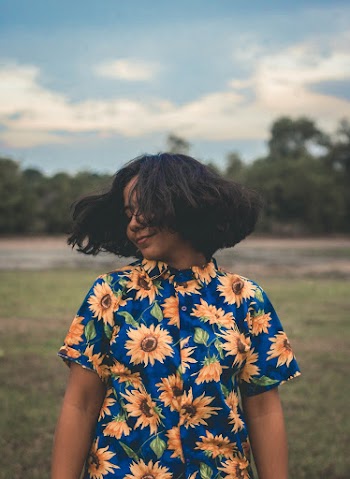 Lady Wearing Blue and Yellow Floral Top