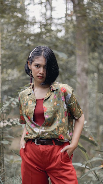 Lady Wearing Red and Green Floral Top And Red Pants