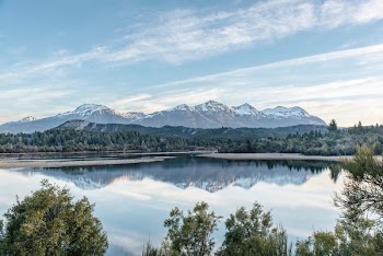 lake in distance of mountain and trees