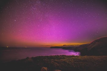landscape photo of body of water under starry sky