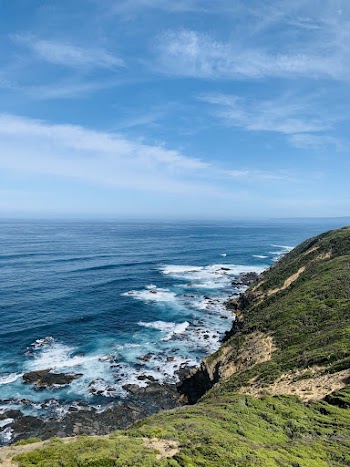 Landscape Photo of Brown and Green Mountain and Body of Water