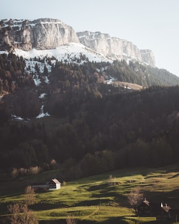 Landscape Photo of Cabin Near Snow Covered Mountain
