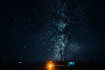 landscape photo of camping tents under starry nighttime