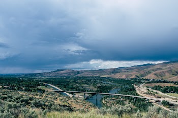 Landscape Photo of Gray Concrete Bridge Under Body of Water