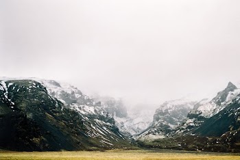 landscape photo of mountain covered with snow and fog
