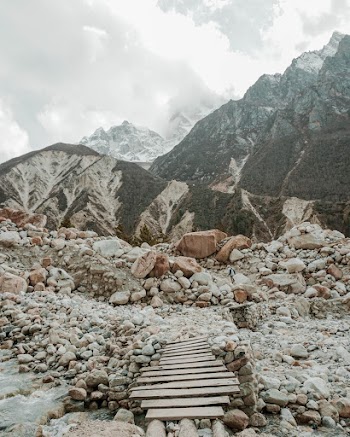 Landscape Photo of Mountains Under Cloudy Sky