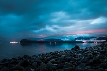 landscape photo of rocks near the body of water