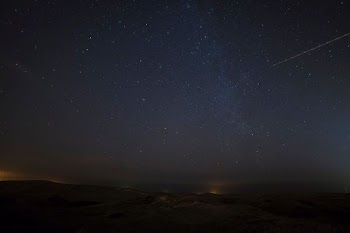 landscape photograph of meteor falling in the sky