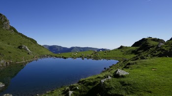 Landscape Photography of Body of Water Near Hill