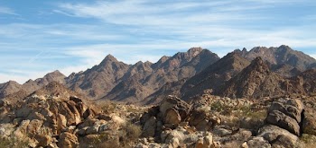 Landscape Photography of Brown Mountain Under White and Blue Cloudy Sky during Daytime
