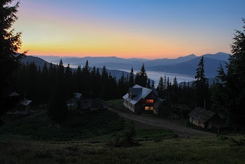 Landscape Photography of House Surrounded by Pine Trees Overlooking Mountain Range