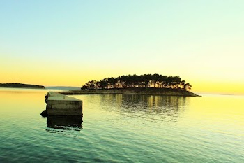 landscape photography of island in middle of body of water