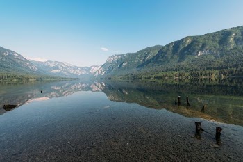 landscape photography of lake surrounded by mountains