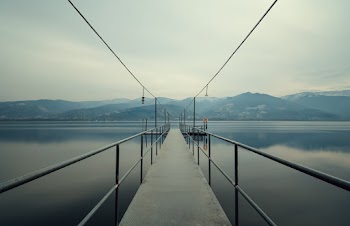 Landscape Photography of Metal Footbridge Leading to the Lake