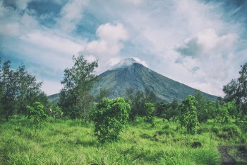 Landscape Photography Of Mountain Under Cloudy Sky
