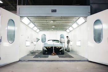 landscape photography of silver muscle car in hangar