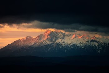 landscape photography of snow mountains under nimbus clouds