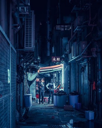 landscape photography of two persons standing beside trash can