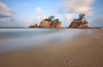 Landscape Photography of Two Rock Formations on Body of Water