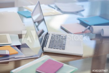 Laptop and paperwork on desk