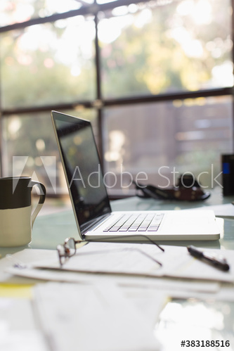 Laptop and paperwork on desk