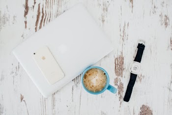 Laptop Beside Cup Of Coffee