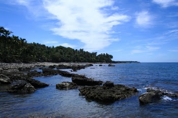 Large Rocks on Seashore Under White Cloudy Sky during Daytime