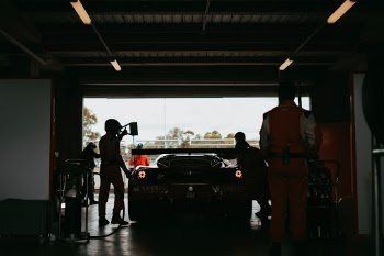 Last weekend I made the long drive to Bathurst to watch the 12 hour GT race that comes on once a year. Every year they close a public road that drives around a mountain to host a 12 hour endurance race. 

This year is my third year and I was blown away with the quality of cars that were there. Like one of my other photos at the same event I took this shot to show the blend between man and machine, to show that behind the race car that is on the track there is a hard working team putting that car together.