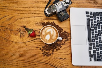 Latte Art Beside Laptop