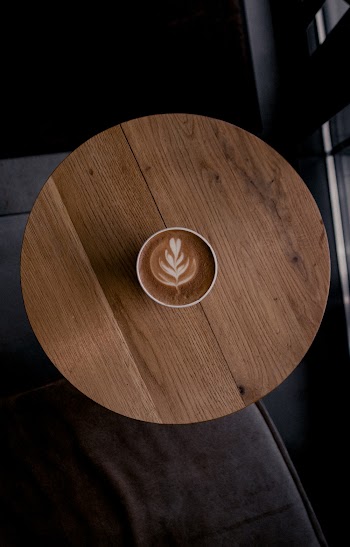 Latte art in cup of coffee on a Round Table