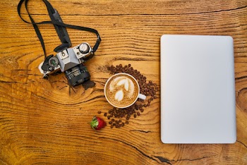 Latte Coffee And Camera On Wooden Surface