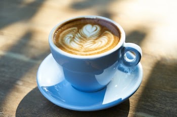 Latte in White Ceramic Mug With Saucer