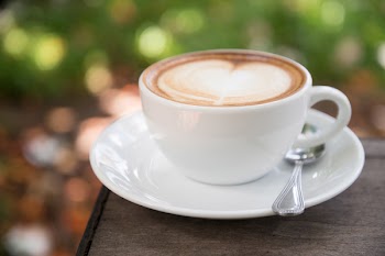 Latte on White Ceramic Cup With Saucer in Macro Photography