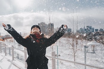 Laughing Woman In Snowy Urban Park