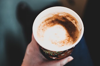Left Hand Holding a Cup of Coffee