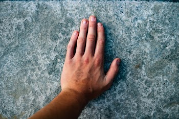 Left Human Hand on Grey Surface