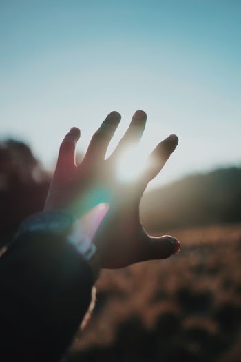 left person hand and bright light