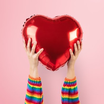 LGBTQ+ community heart balloon held by hands | Free stock photo | High Resolution image