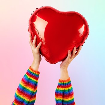 LGBTQ+ community heart balloon held by hands | Free stock photo | High Resolution image