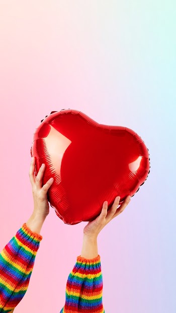 LGBTQ+ community heart balloon held by hands | Free stock photo | High Resolution image