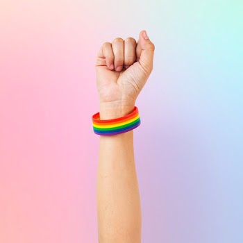 LGBTQ+ pride bracelet with fist in the air | Free stock photo | High Resolution image