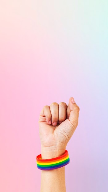 LGBTQ+ pride bracelet with fist in the air | Free stock photo | High Resolution image