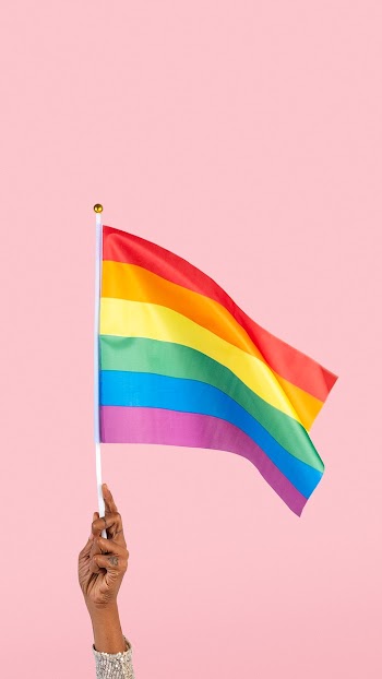 LGBTQ+ pride flag with woman&rsquo;s hand… | Free stock photo | High Resolution image