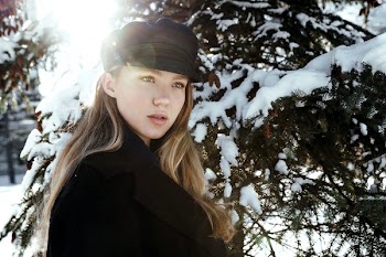 Light Flare Behind Woman In Snowy Wood