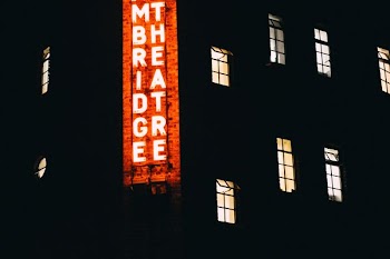 lighted building with signboard