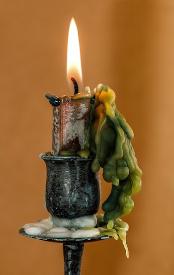 Lighted Candle on Black Steel Holder