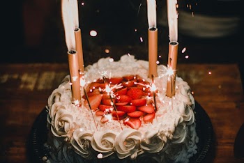 Lighted Candles on White Icing-covered Cake