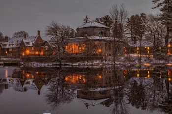 lighted house nearby calm body of water