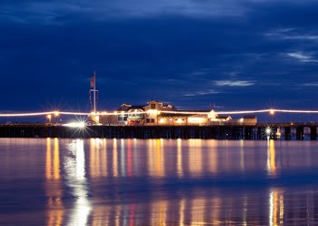 Lighted Houses Near Ocean during Nighttime