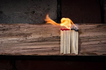 Lighted Matches on Brown Wooden Surface